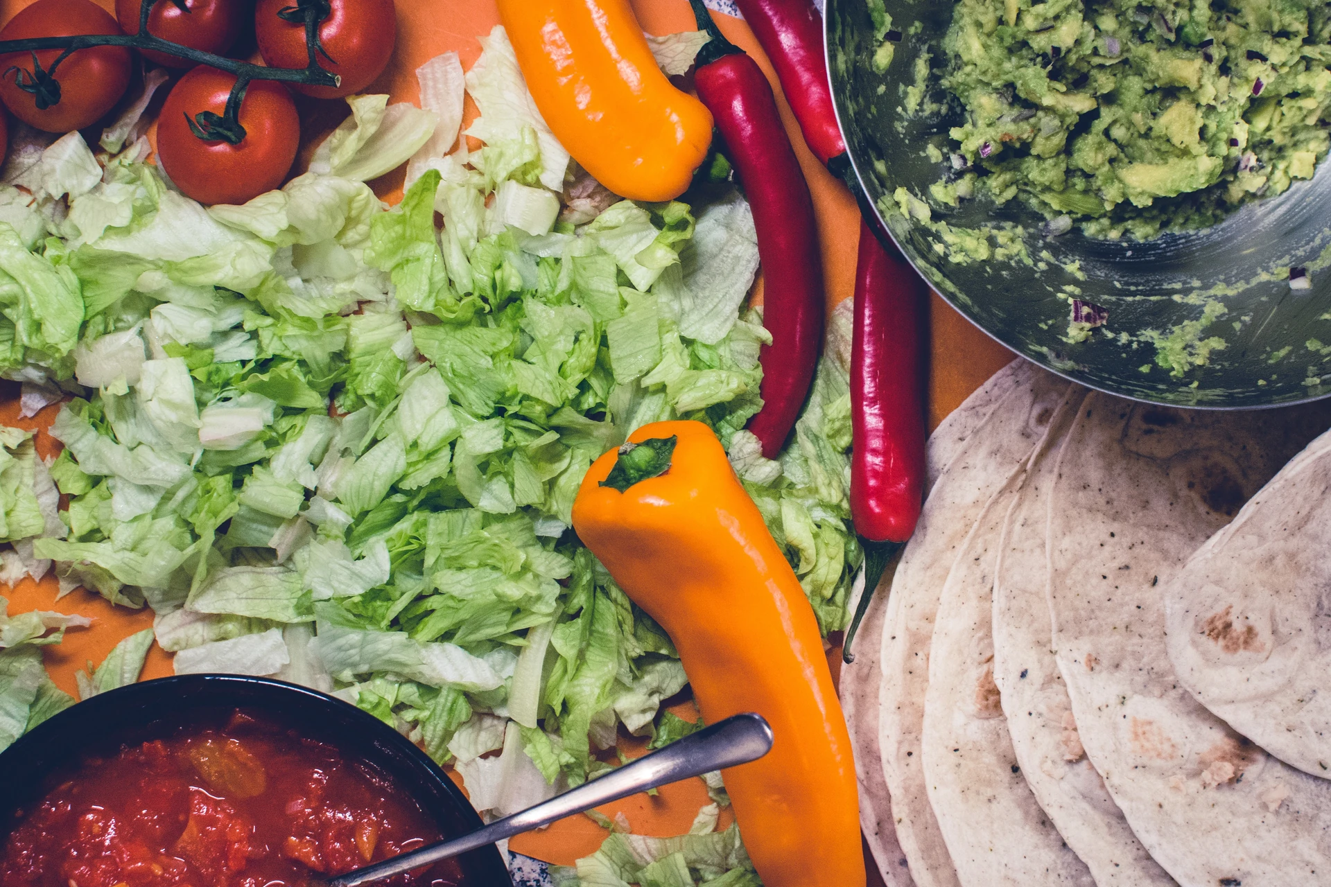 Fresh tortillas, vegetables and guacamole ready for burritos