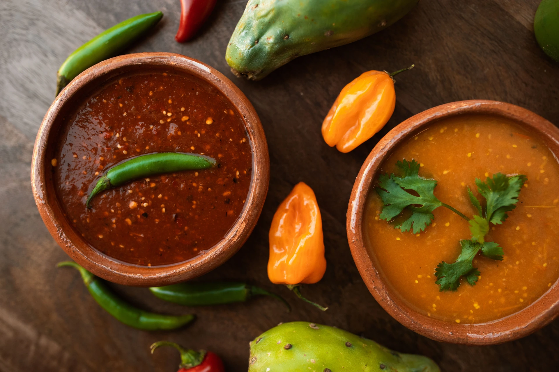 Bowls of colorful salsas with fresh peppers