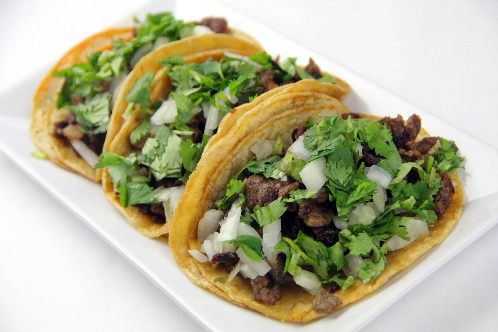 Illustrative street tacos with fresh garnishes