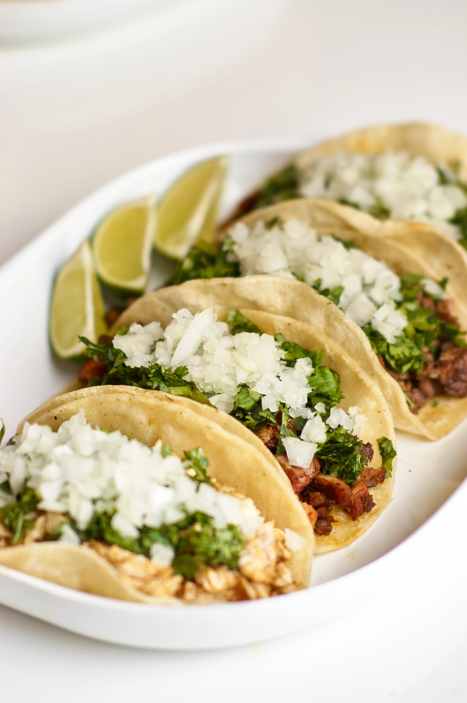 A plate of street tacos with fresh toppings